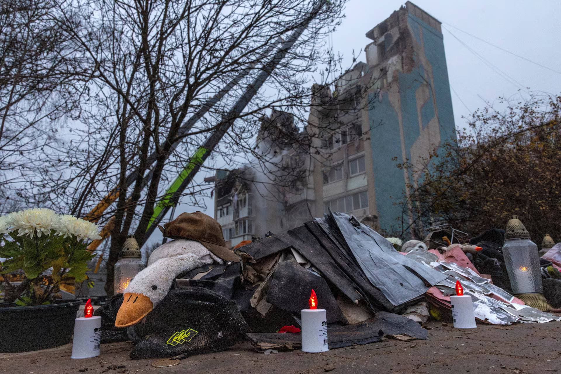 Electric candles glow at a makeshift memorial in front of an apartment building that was hit yesterday by a Russian missile in Ternopil