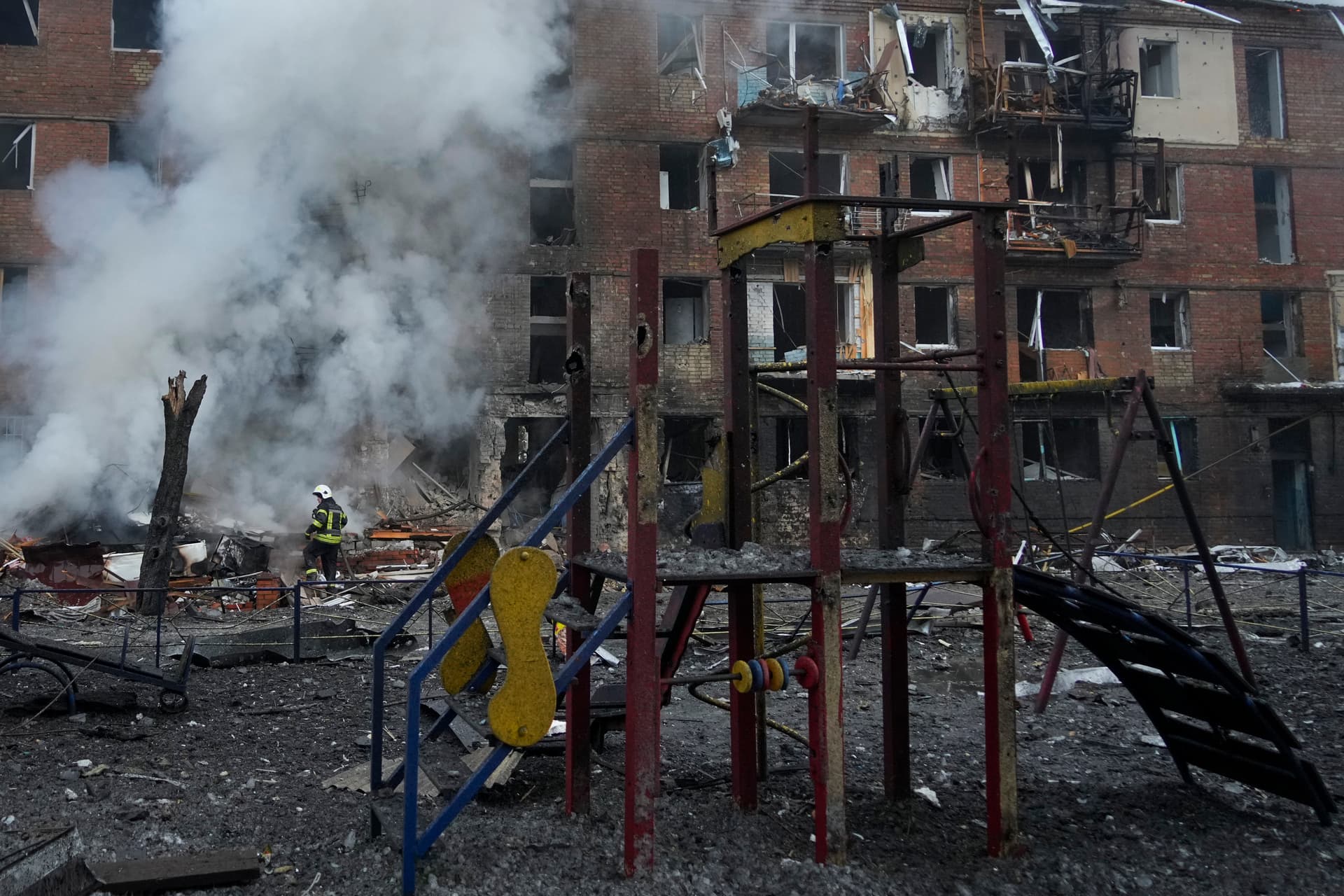 Ukrainian State Emergency Service firefighters work to extinguish a fire at the scene of a Russian shelling in the town of Vyshgorod