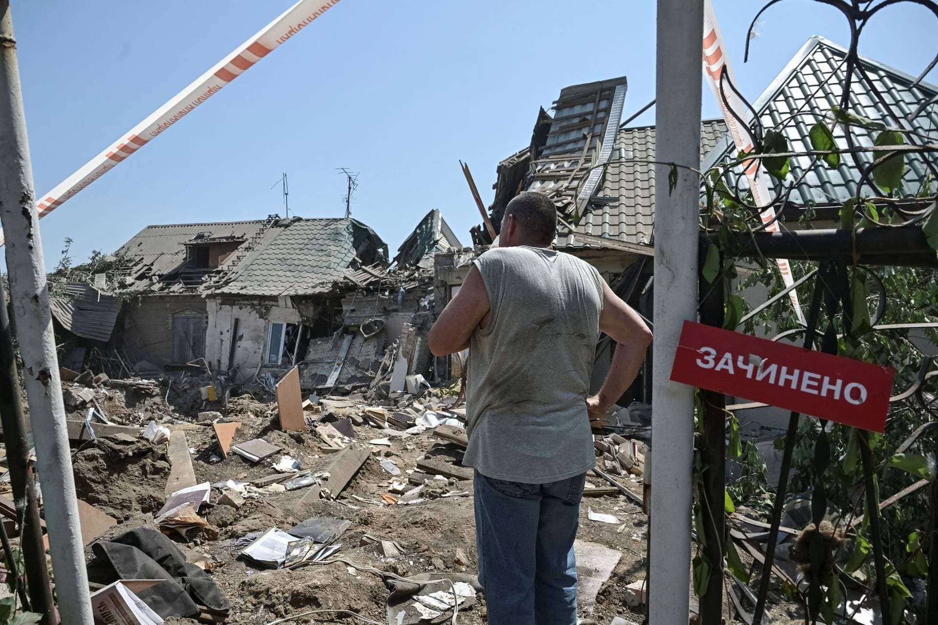 A resident stands at the site of the Russian air strike in Zaporizhzhia