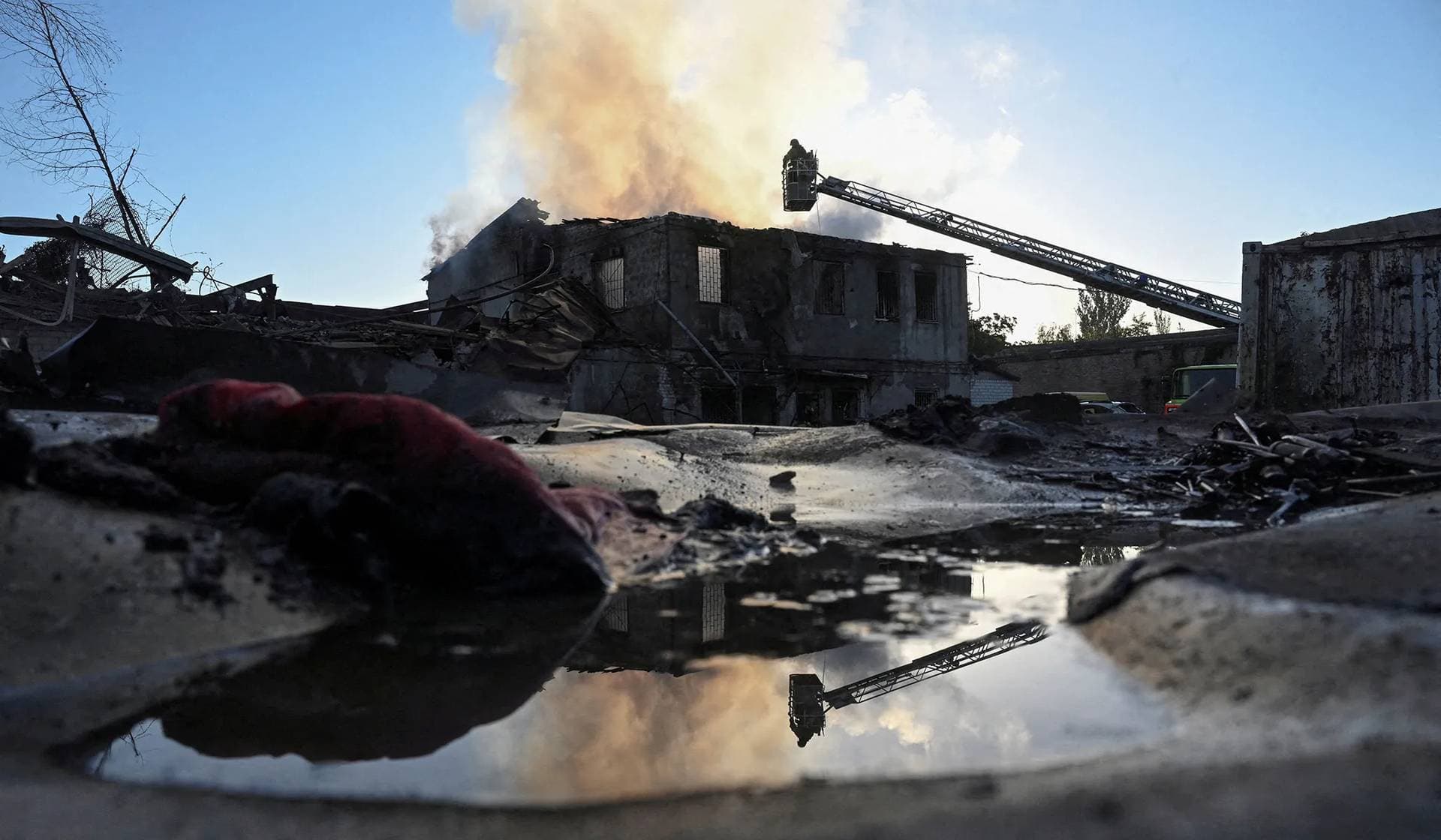 Firefighters work at the site of a private enterprise damaged during a Russian air strike in Zaporizhzhia