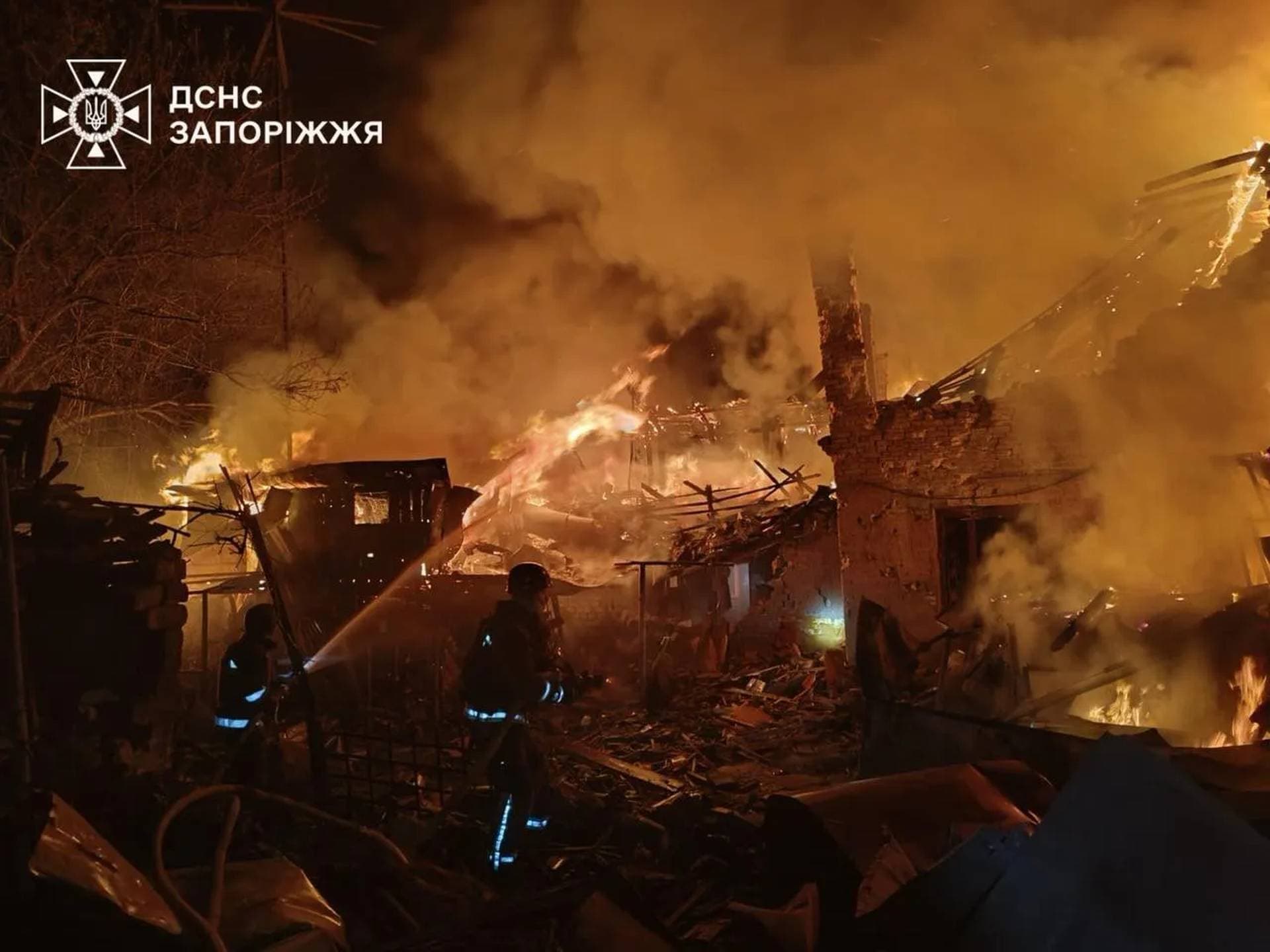 Firefighters work at the site of buildings hit during the Russian missile strike in Zaporizhzhia