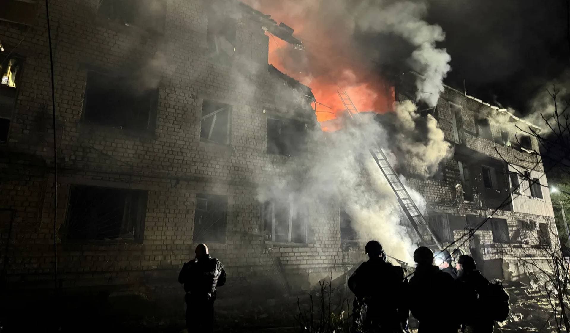 Rescuers work at the site of an apartment building hit by a Russian drone strike in Zaporizhzhia