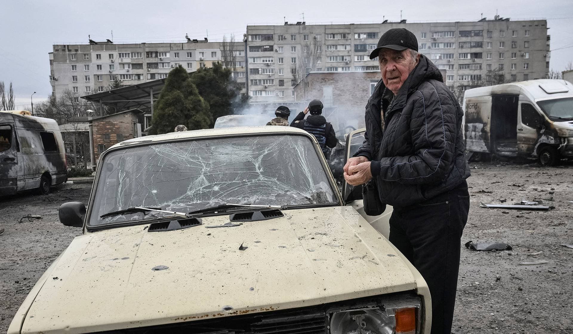 A resident inspects his damaged car at the site of the Russian drone strike in Zaporizhzhia