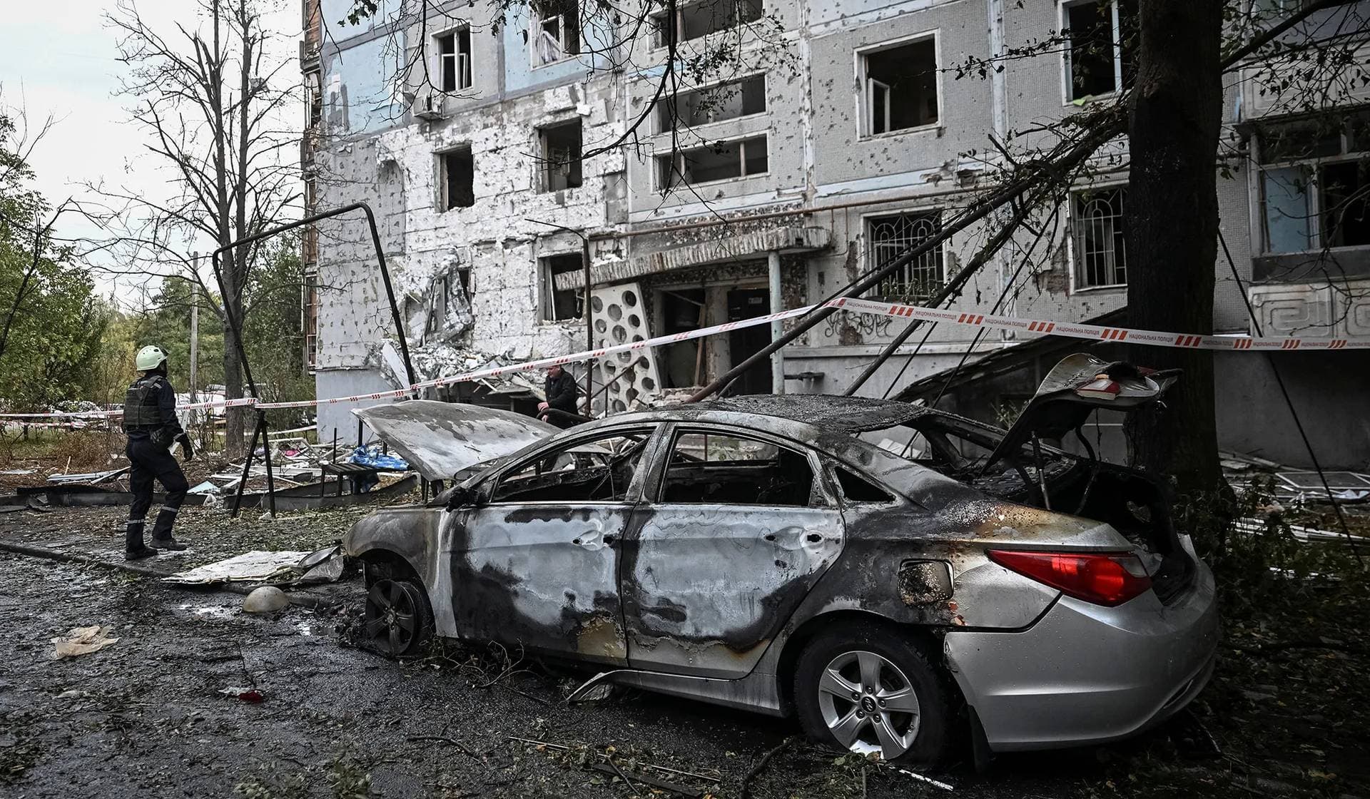 A rescuer works at a site of the apartment building damaged by a Russian drone strike in Zaporizhzhia