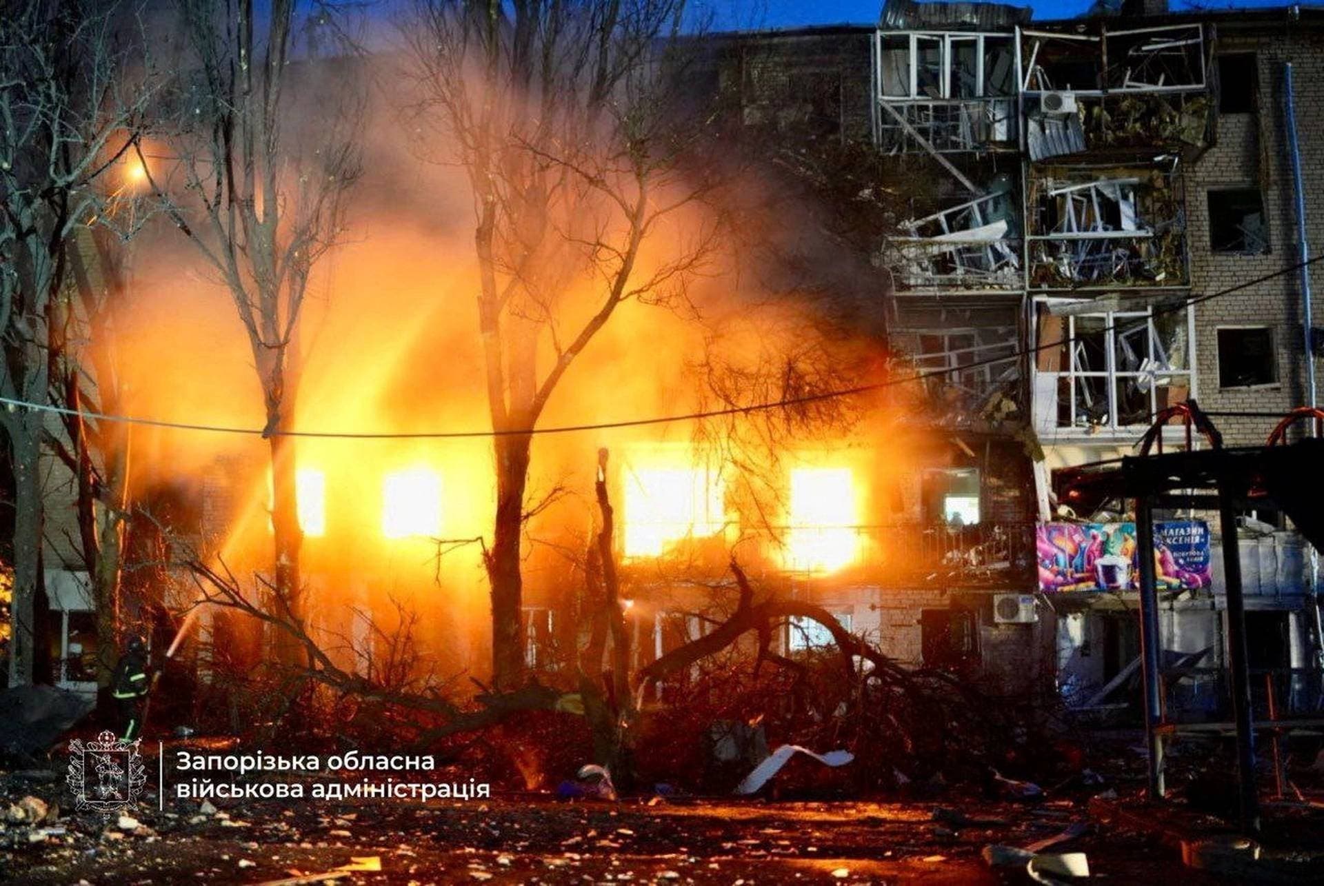 Firefighters work at the site of an apartment building hit during a Russian drone and missile strike in Zaporizhzhia