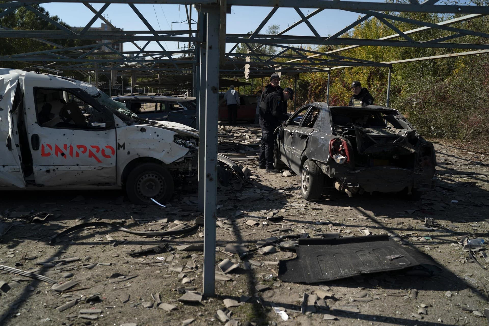 Police officers work at a site where several cars were damaged after a Russian attack in Zaporizhzhia
