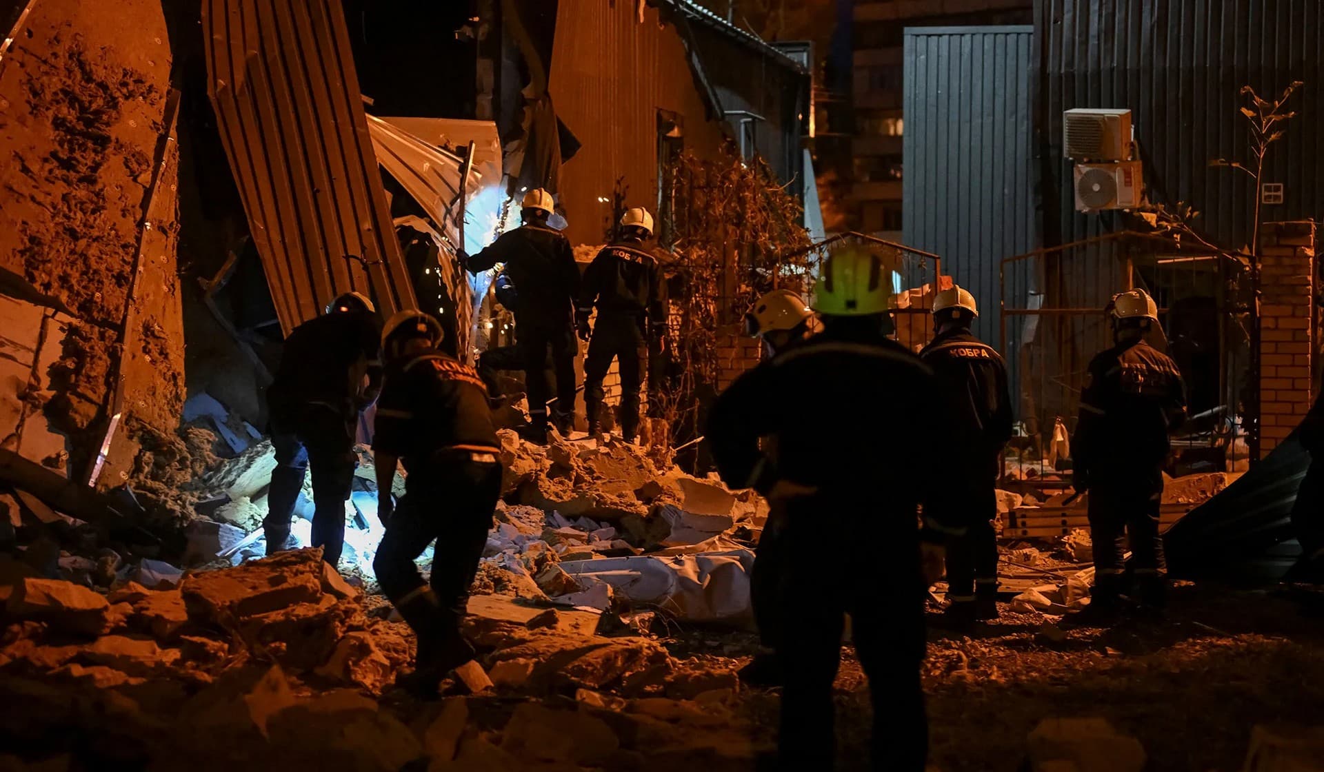 Rescuers work at the site where a building was destroyed during a Russian missile strike in Zaporizhzhia