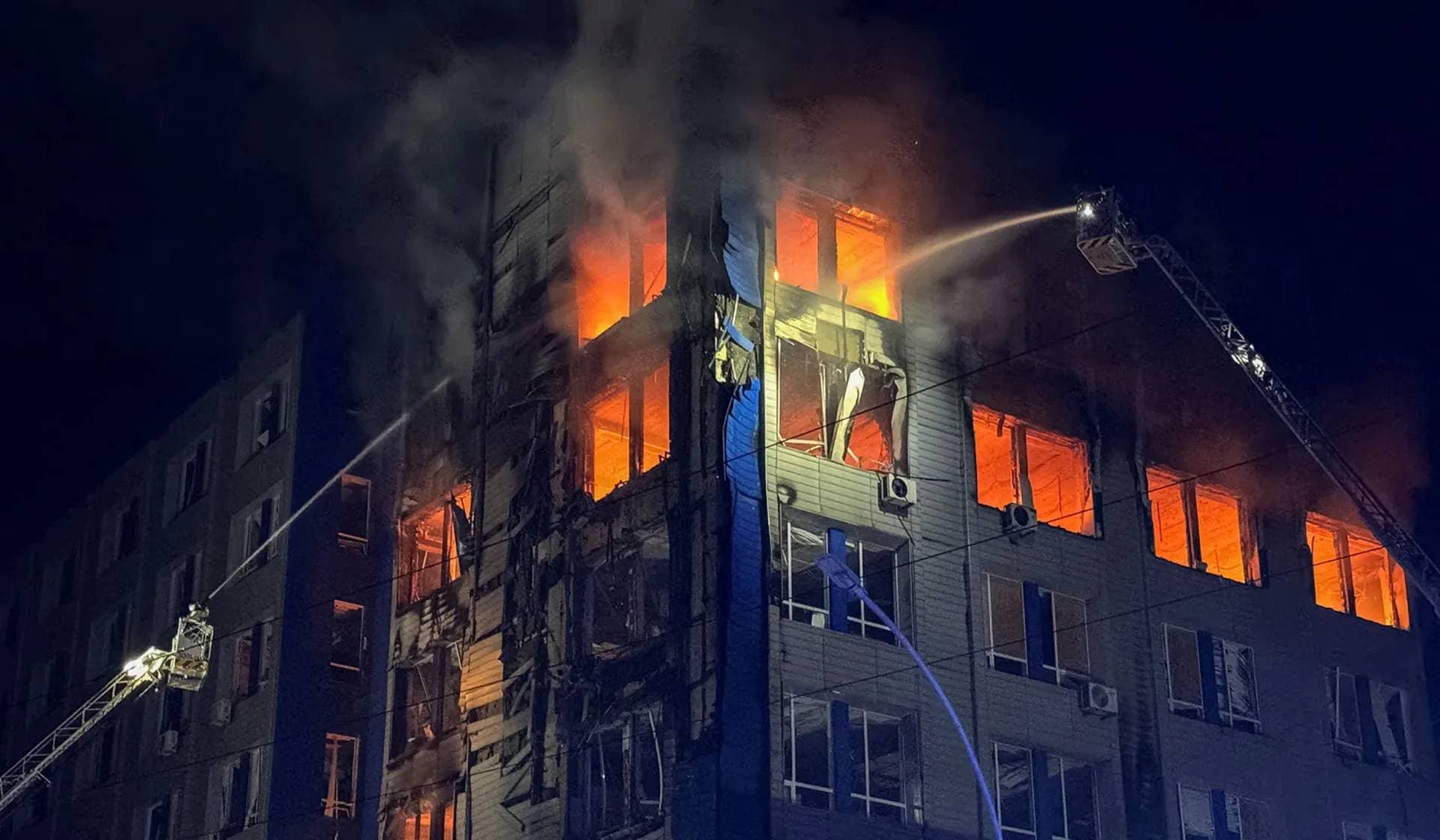 Firefighters work at the site of a Russian drone strike in Zaporizhzhia