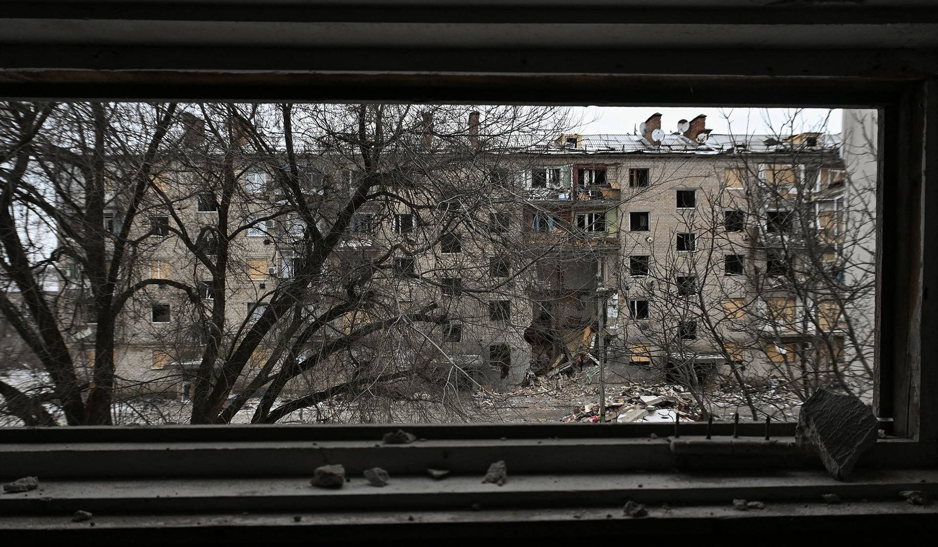 An apartment building damaged by Russian military strikes in the frontline town of Komyshuvakha