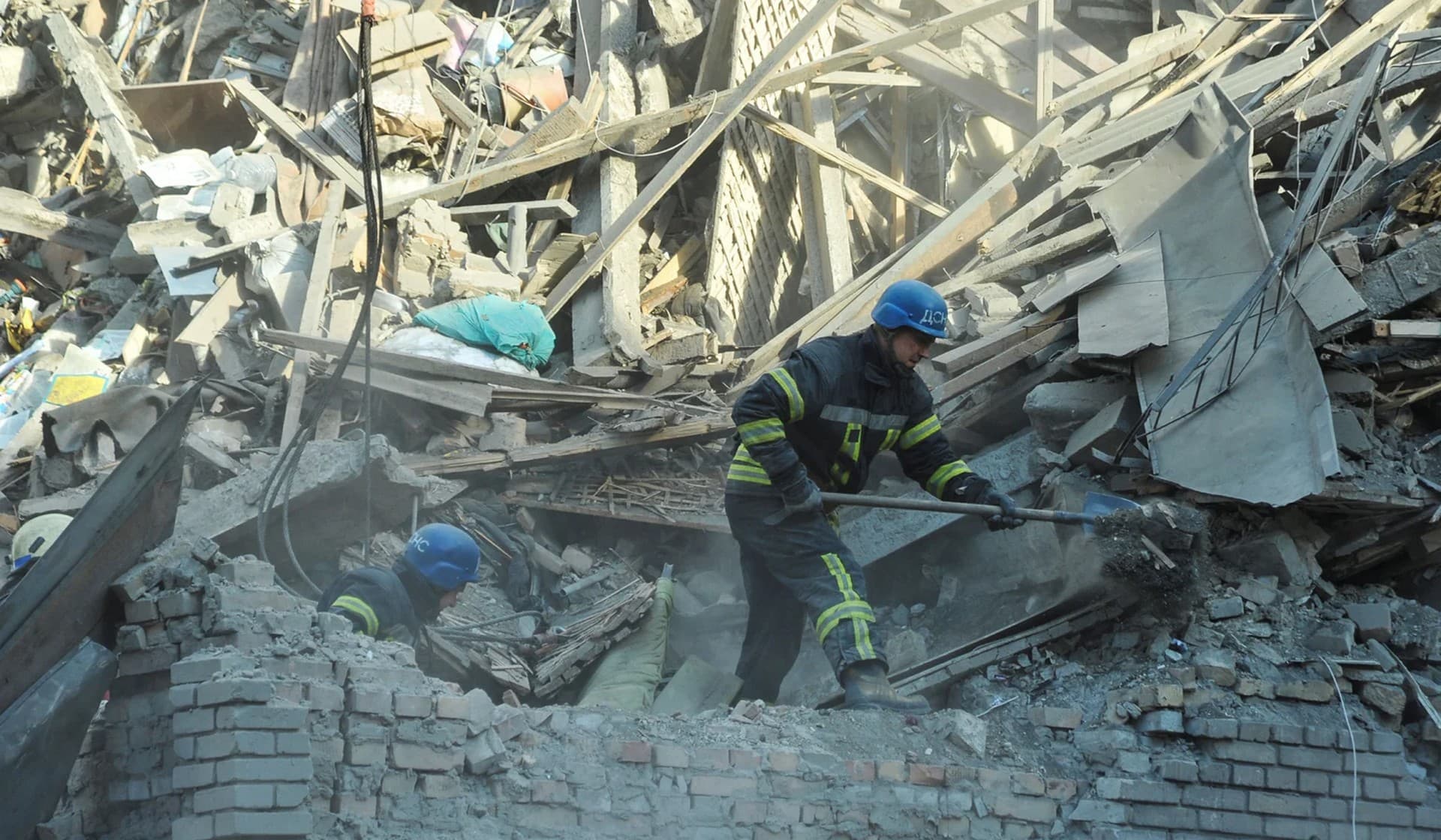 Rescuers work at the site of a residential building heavily damaged by a Russian missile strike in Zaporizhzhia