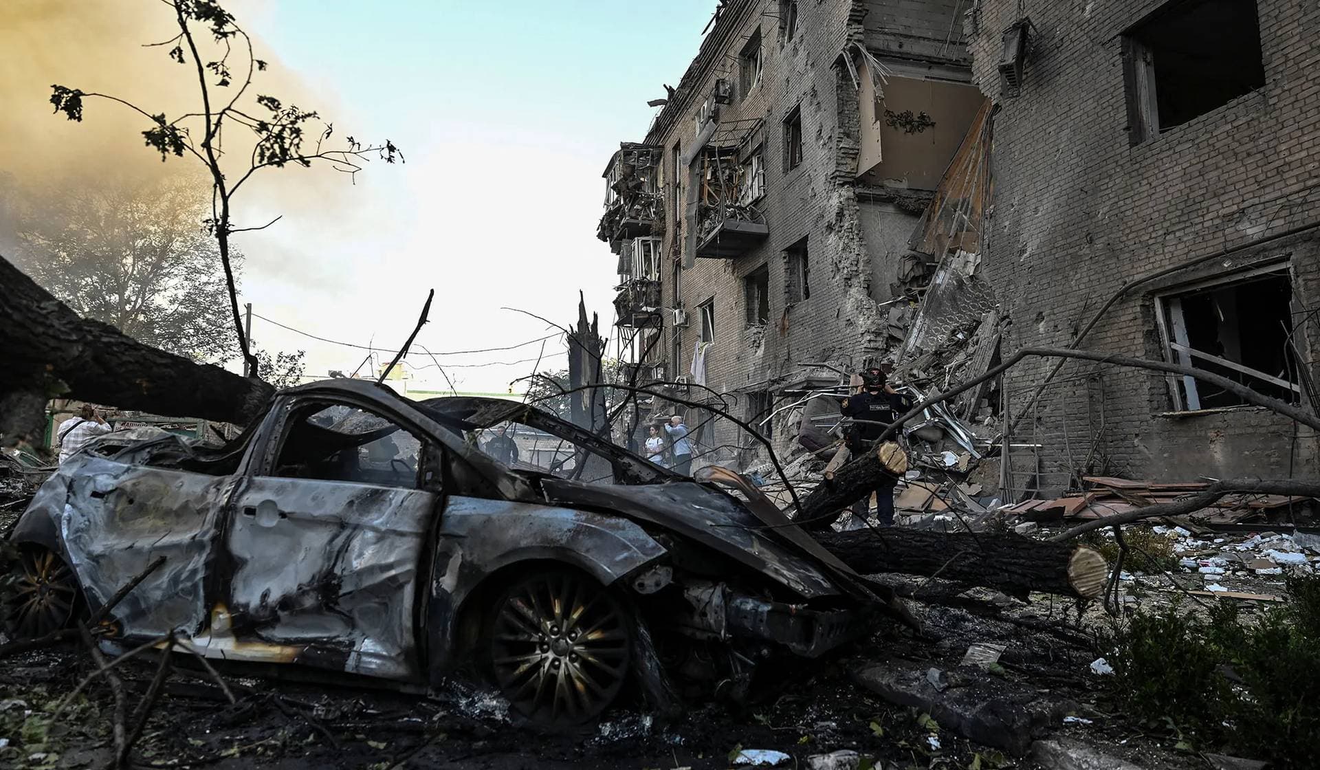 A rescuer works at a site of an apartment building hit by a Russian air strike in Zaporizhzhia