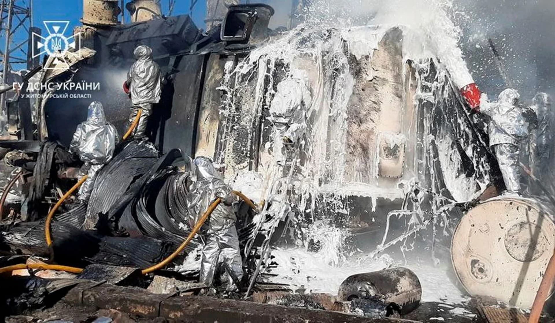 Firefighters work to put out a fire in an energy infrastructure facilities damaged by a Russian missile strike in Zhytomyr
